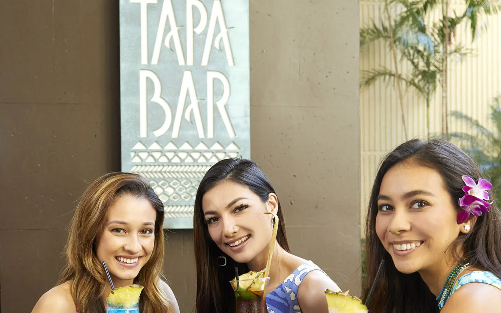 Three smiling girls at the Tapa Bar