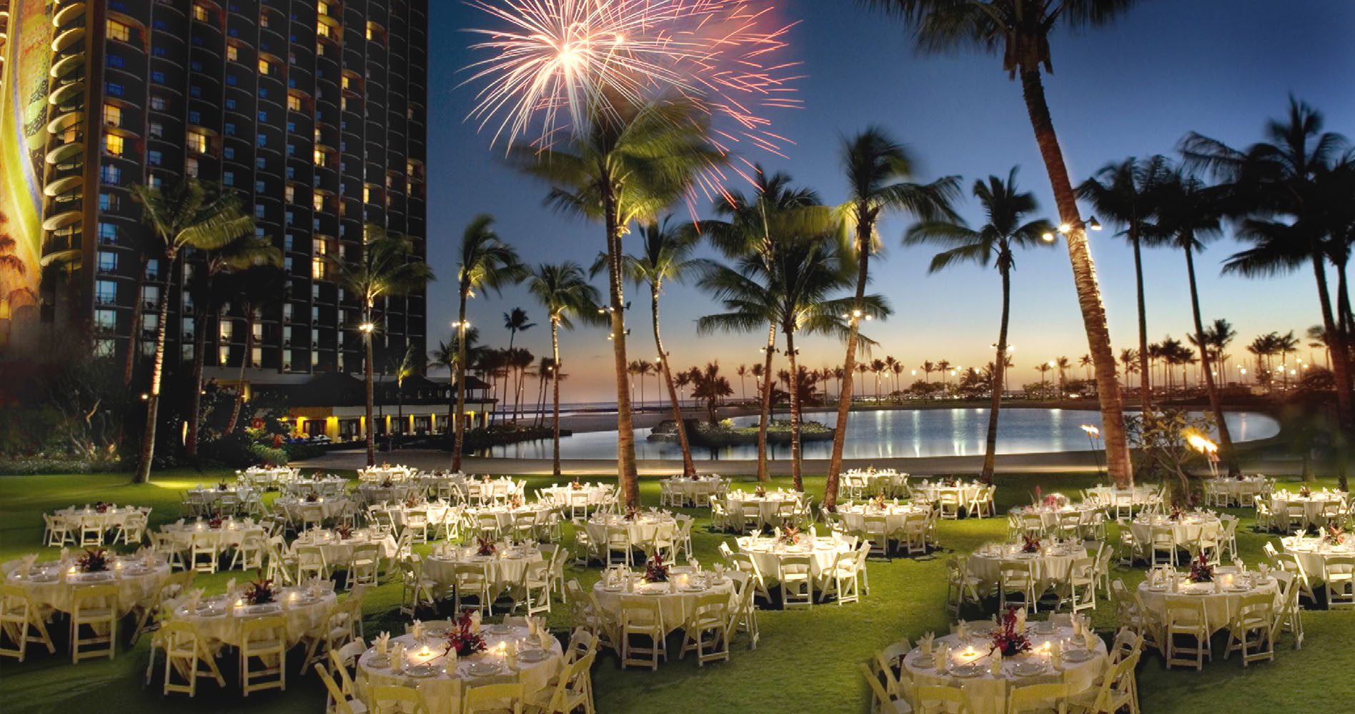 The Great Lawn set at night with banquet tables with fireworks