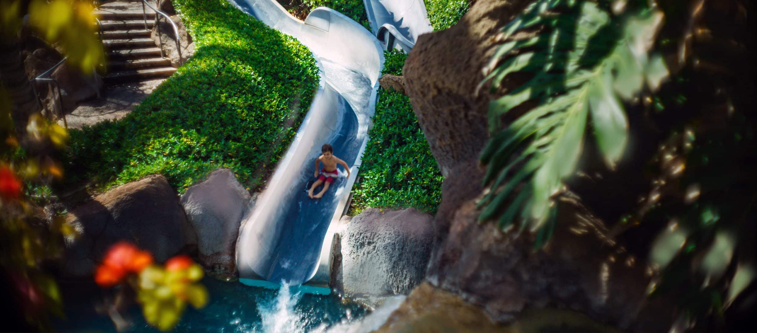A child on a waterslide at the Hilton Hawaiian Village