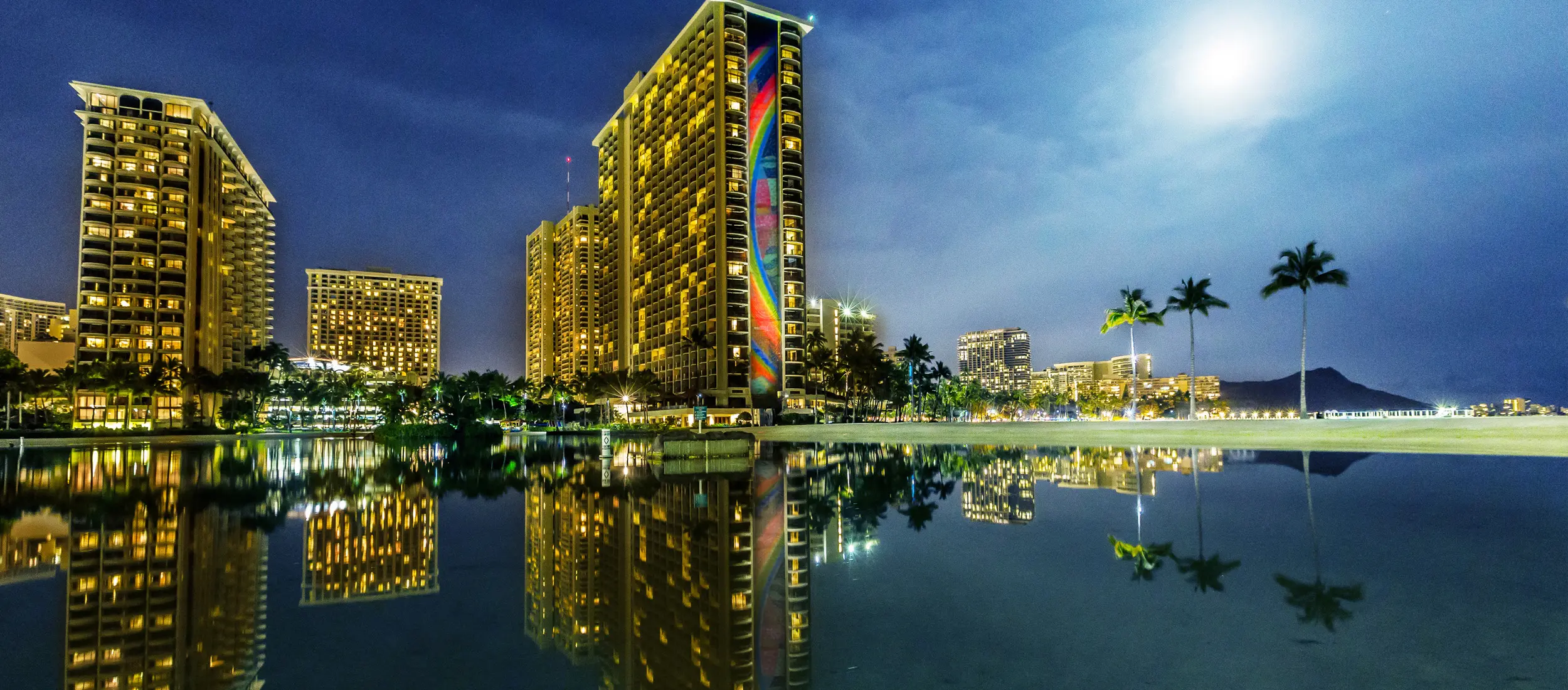 Hilton Hawaiian Village in the evening with Rainbow Tower by moonlight