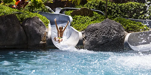 A child on a waterslide at the Hilton Hawaiian Village