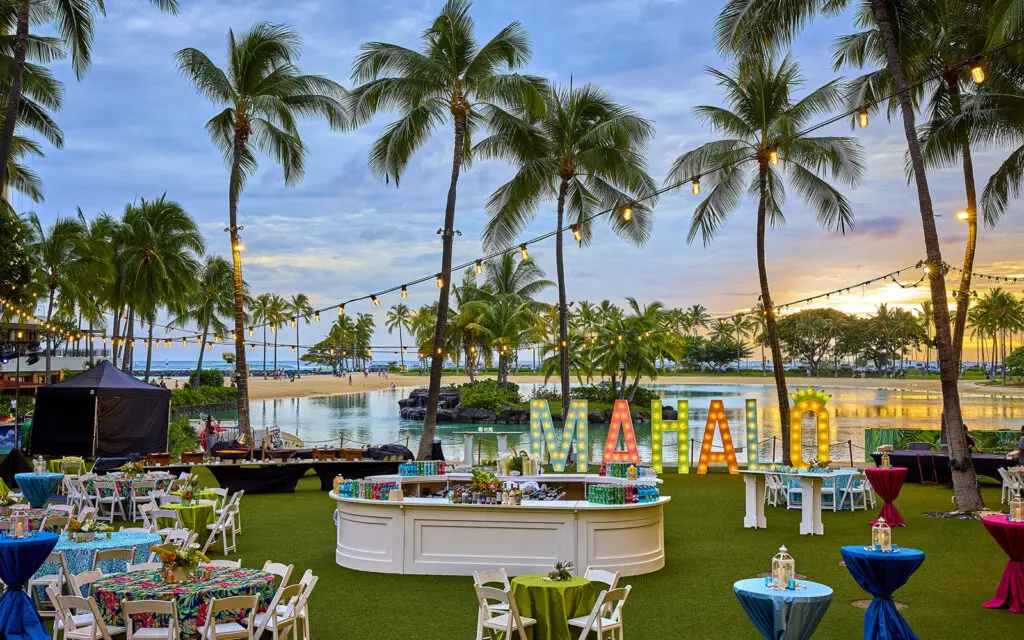 The Great Lawn at Hilton Hawaiian Village set for an event with a large Mahalo sign on lawn