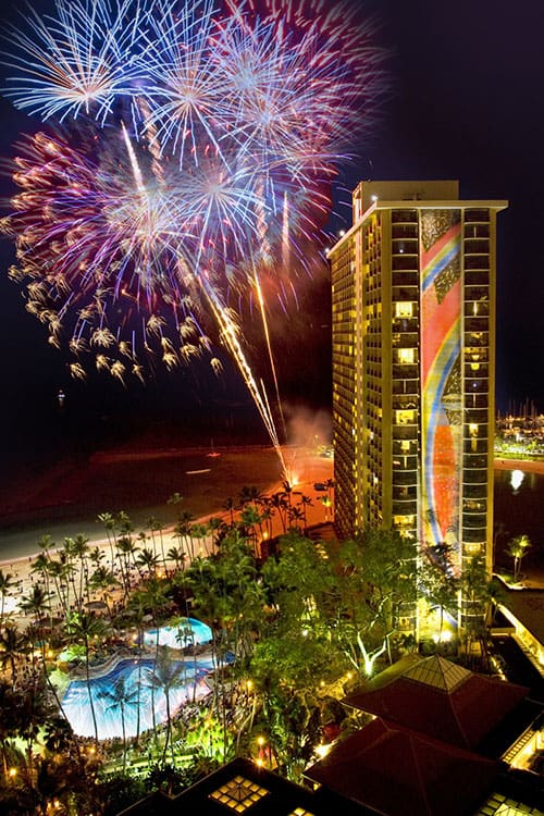 Friday Night Fireworks at night on the beach with the Rainbow Tower on the right.