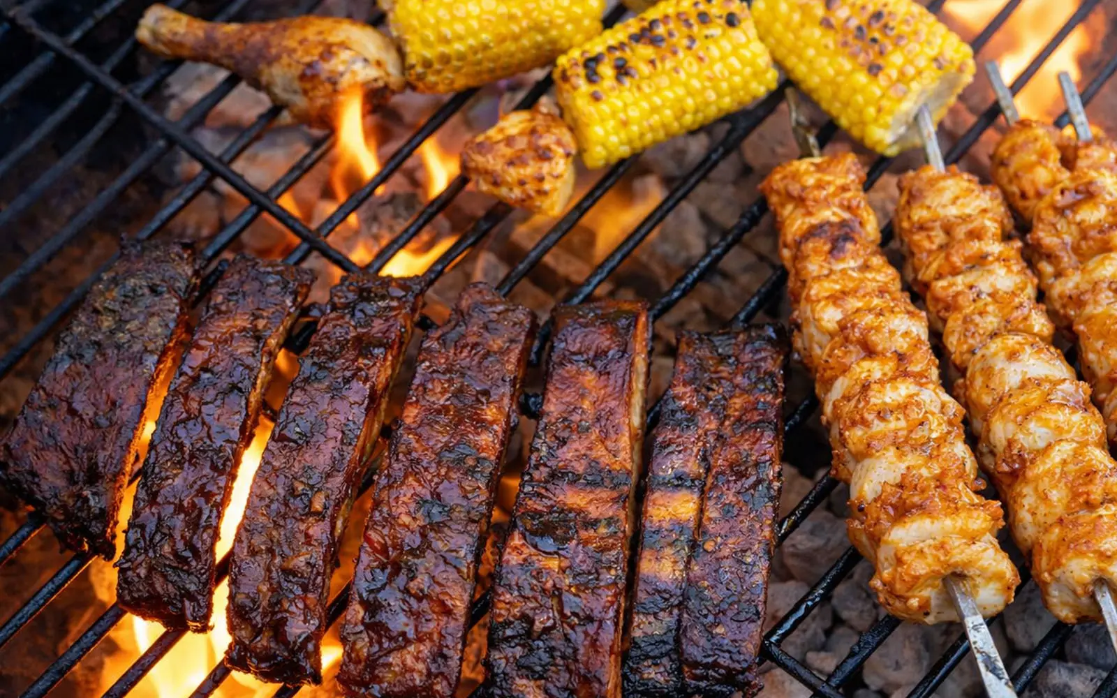 Barbecue grill wtih ribs, chicken skewers and corn
