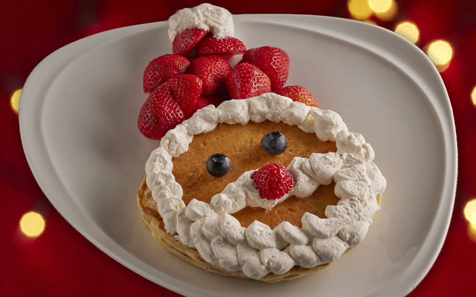 Santa Claus pancake made with strawberries and whipped cream