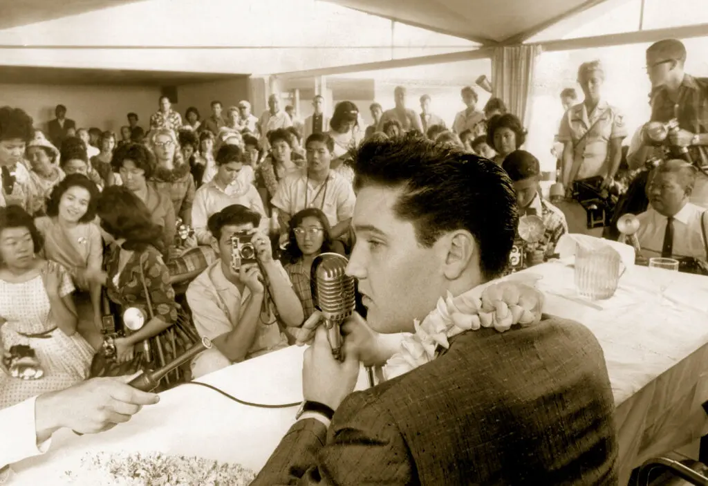 Elvis Presley answers questions during a press conference attended mainly by representatives of high school papers in 1961.